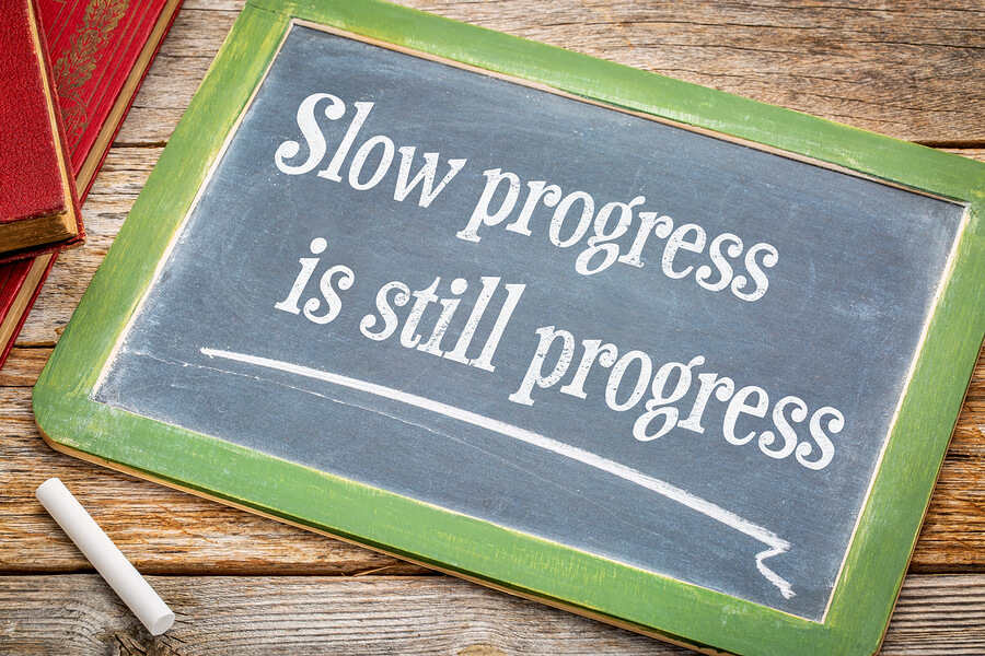 A chalkboard that says slow progress is still progress